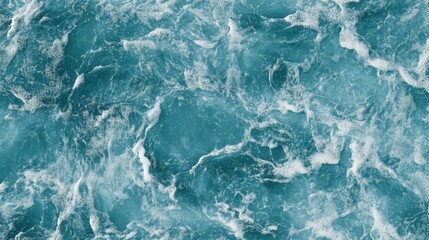 Fototapeta premium A stunning aerial view of a deep blue ocean, with frothy waves and wispy clouds dotting the horizon 