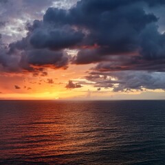 Obraz premium Dramatic Sunset Over Serene Ocean Horizon with Vibrant Sky and Stormy Clouds
