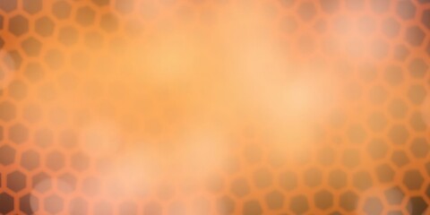 A blurred image of an orange hexagon pattern on a gradient background creating a sense of depth and dimensionality, abstract patterns, orange hexagons