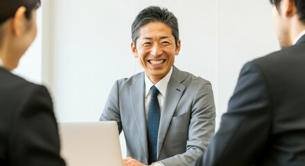 Fototapeta premium A middle-aged male employee negotiating with a client smiling