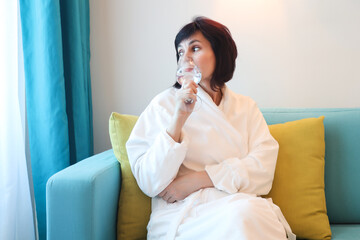 Celebrating Freedom: A Woman in a White Robe Sips Champagne Luxurious Hotel Room, Embracing the Joy of Vacation Away from Work Responsibilities.