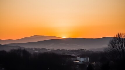Sunset Over Mountains and a Small Town