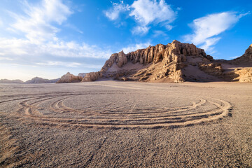 Desert sand ground and Yardang landform mountain natural landscape in Xinjiang, China. Road trip in no man's land. Outdoor natural background.