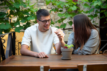 Smiling young people in the garden laughing and communicating.