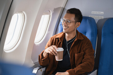 Happy man airplane travel, Portrait of man with journey. © NINENII