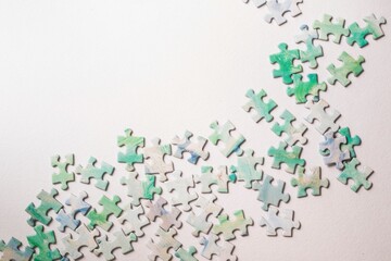 Colorful jigsaw puzzle pieces arranged on a white background