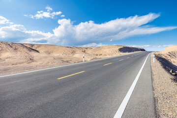 Asphalt highway road and desert natural landscape in Xinjiang, China. road trip.