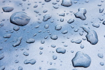 Drops on a dark gray metal texture.
