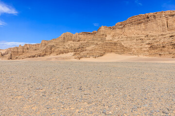 Desert sand ground and Yardang landform mountain natural landscape in Xinjiang, China. Road trip in...