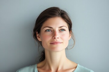 Woman with serene look gazing upwards in soft light