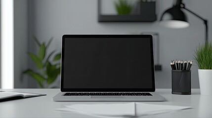 A sleek, modern workspace featuring a blank laptop screen, minimalist decor, and greenery for a refreshing touch.