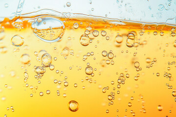 Golden bubbly liquid fizzy drink with carbonated bubbles rising