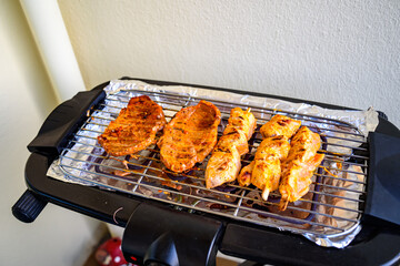 The meat is cooked on an electric grill