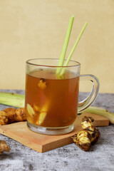 Closeup photo of a healthy hot red ginger drink with a mixture of lemon