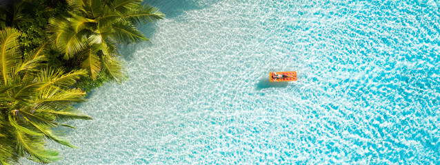 Top above high angle aerial drone view of fit attractive girl floating lying on rubber mattress clean clear pure sea water enjoy joy relax sunny weather visiting exploring new countries world