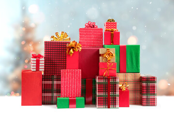 Christmas, New Year gift boxes for holidays promotions. Red, green, checkered and polka dot wrappers, lush bows.