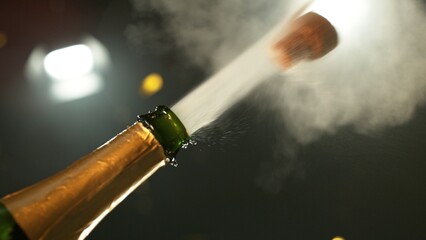 Celebration theme with splashing champagne on black background.