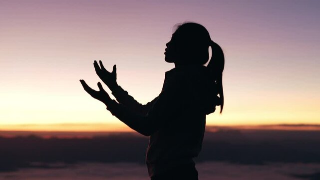 Silhouette of woman in intense prayer before betrayal and crucifix, gethsemane, prayer ministry.4k slow motion video.