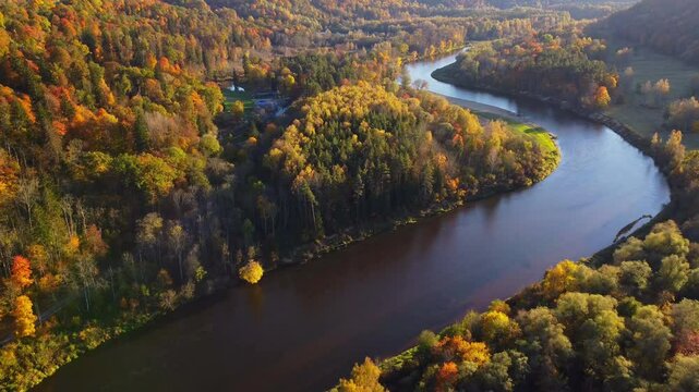 The Autumn Capital Of Latvia; Slow Aerial Reverse Shot Revealing The Spectacular Fall Colors And Nature Landscapes Over The Picture Perfect (Gauja River Valley) In Sigulda, Latvia.