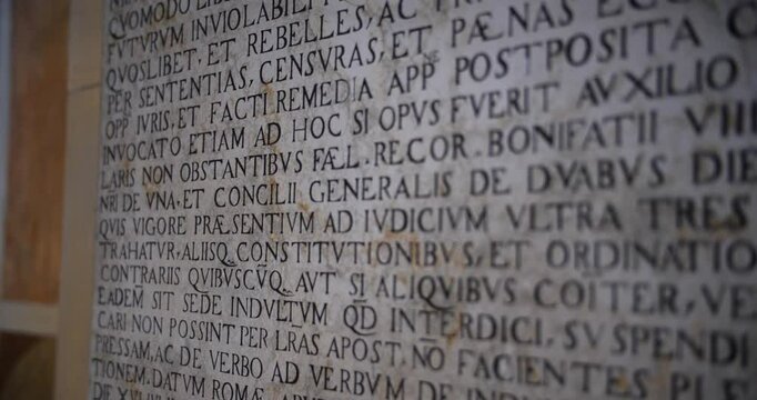 Close view of a wall full of latin word in a catholic temple.