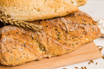 Homemade natural breads. Different kinds of fresh bread as background, perspective view with copy space