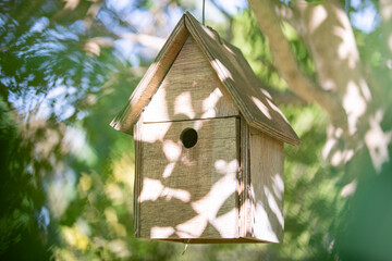 Wooden birdhouse hanging on a tree