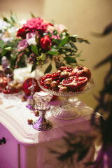 Festive centerpiece with pomegranate, flowers, and decorative accents