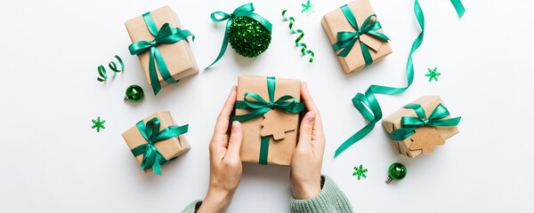 Woman hands holding gift box, preparing surprise for holiday, top view, Christmas and New Year concept