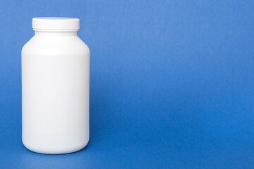 supplement pills with medicine bottle health care and medical top view. Vitamin tablets. Top view mockup bottle for pills and vitamins with green leaves, natural organic bio supplement, copy space