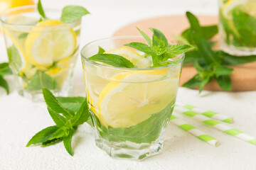 Mojito cocktail. Refreshing mojito cocktail with lime, lemon and mint in a tall glass with a stick