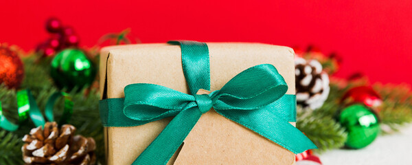 New Year Christmas mood, gift box, branches of a christmas tree, New Year decorations on a colored background