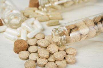 Vitamin capsules and dietary supplements on a light background.