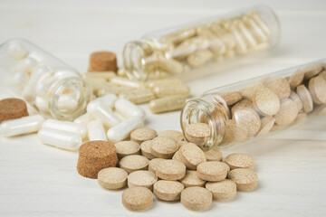 Vitamin capsules and dietary supplements on a light background.