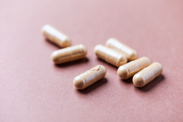 Korean Ginseng capsules. Concept for a healthy dietary supplementation. Bright paper background. Close up.	