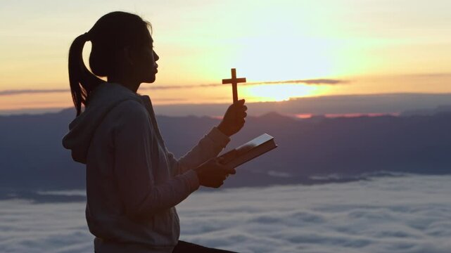  Silhouette of Person hands open palm up worship God helping repent catholic easter lent mind pray Christian religion.  prayer woman worship God in the morning with sunrise.