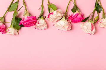 Rose essential oil on a textured background.Roses and a bottle of rose perfumed water.Aromatherapy treatment. Beauty concept. Spa procedure.Natural organic oil.Anti-stress,detox relax.Place for text