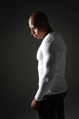 Athletic african american man in jeans and long sleeve posing isolated on grey