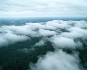 Obraz premium Aerial view of remote mountains shrouded in clouds, a breathtaking landscape of misty peaks and valleys hidden within a sea of clouds The majestic mountains pierce the clouds, creating a dramatic