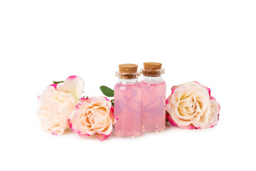 Rose essential oil isolated on white background.Roses and a bottle of rose perfumed water. Aromatherapy treatment. Beauty concept. Spa procedure.Natural organic oil.Anti-stress and detox relax.