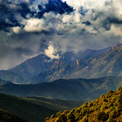 Corsican landscape with mountains in the background and spectacular clouds