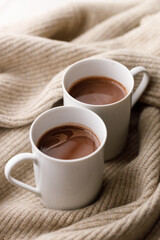 Cups of delicious hot chocolate and artisanal gift box