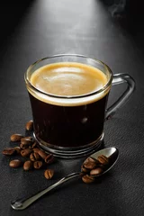 Küchenrückwand glas motiv Kaffee und Kaffeebohnen espresso with crema in glass cup and coffee beans near on black table  © alter_photo