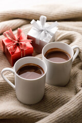 Cups of delicious hot chocolate and artisanal gift box