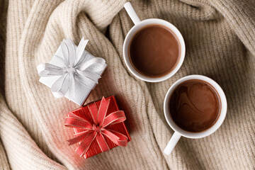 Cups of delicious hot chocolate and artisanal gift box