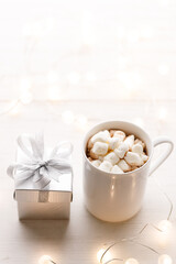 Cups of delicious hot chocolate and artisanal gift box