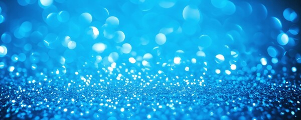 Sparkling blue particles create a shimmering effect on a surface during a festive event