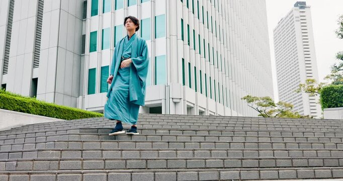 Japanese man, pride and style as traditional clothes, outfit or dress for heritage in city. Male person, outdoor and steps for walk, culture and travel with casual kimono or yukata for summer fashion