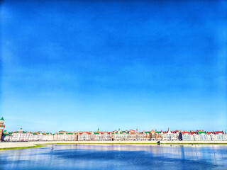 Beautiful houses on the Bruges waterfront in Yoshkar-Ola. Beautiful waterfront houses along the Bruges-style canal in Yoshkar-Ola under clear blue sky