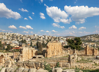 Roman ruins (against the background of a beautiful sky with clouds) in the Jordanian city of Jerash (Gerasa of Antiquity), capital and largest city of Jerash Governorate, Jordan