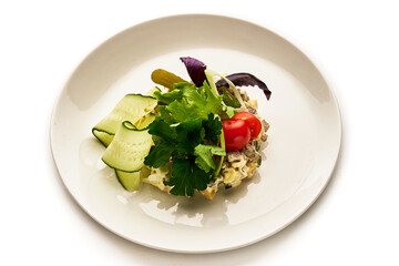 A plate of food with a variety of vegetables including cucumbers, tomatoes